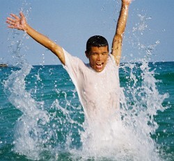 Thai swiimer in wet clothes cotton swim shirt white beach koh samet thailand
