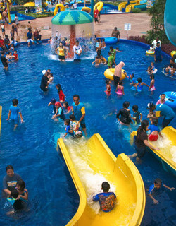 waterpark slide into pool with swimmers in clothes
